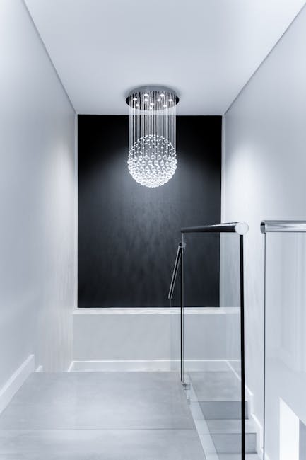 Home Sleek contemporary hallway featuring a stunning glass chandelier and minimalist design.